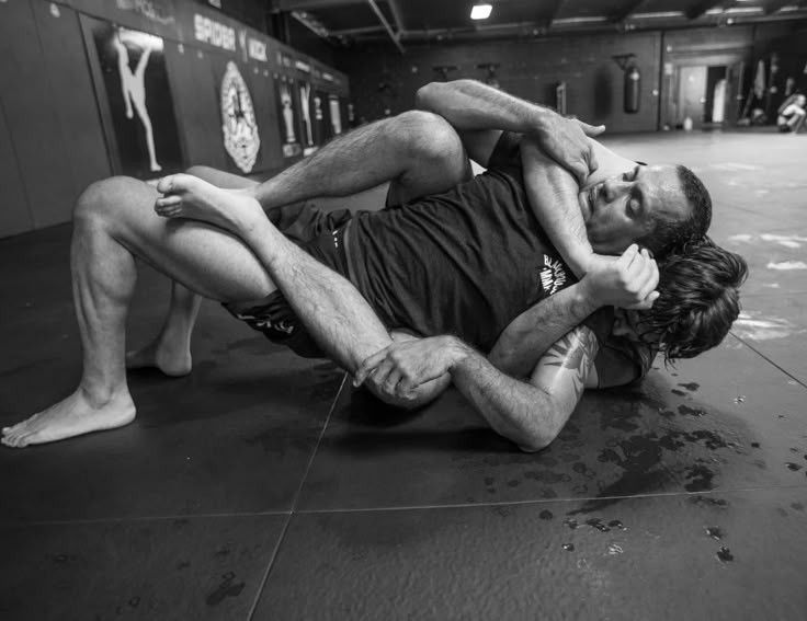 Two athletes grappling on the mat